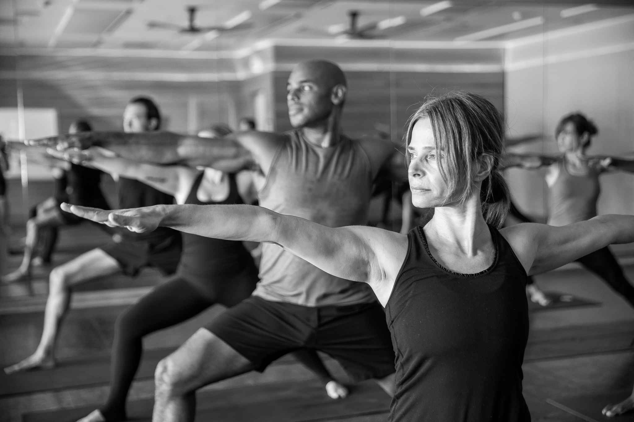 Man with tattoos in plank pose at Powerflow Yoga.